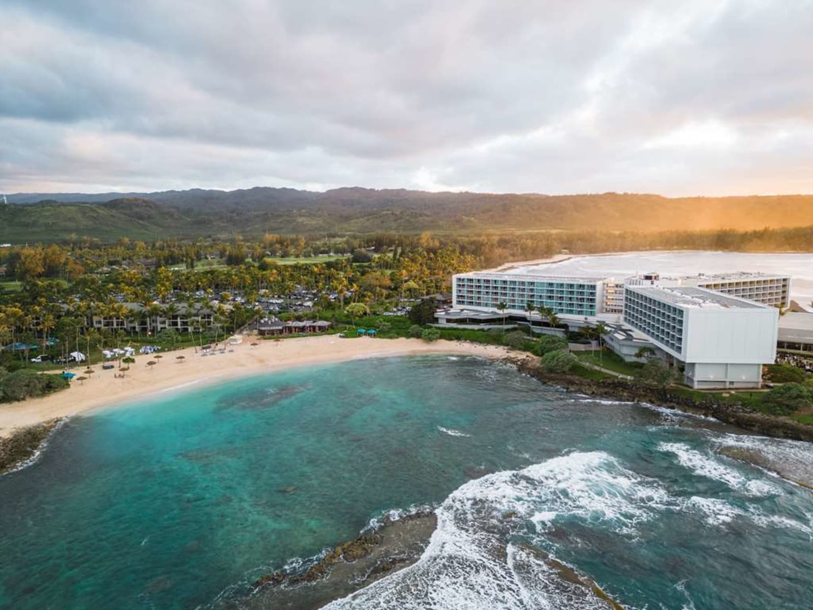 An aerial daytime view of the Turtle Bay peninsula and its protected cove on Oahu's North Shore