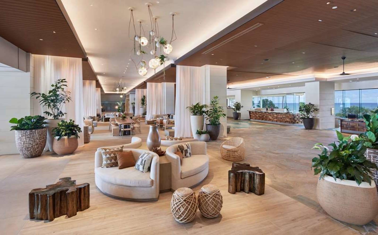 The open-air lobby lounge at The Ritz-Carlton O'ahu, Turtle Bay with views through to the ocean on both sides