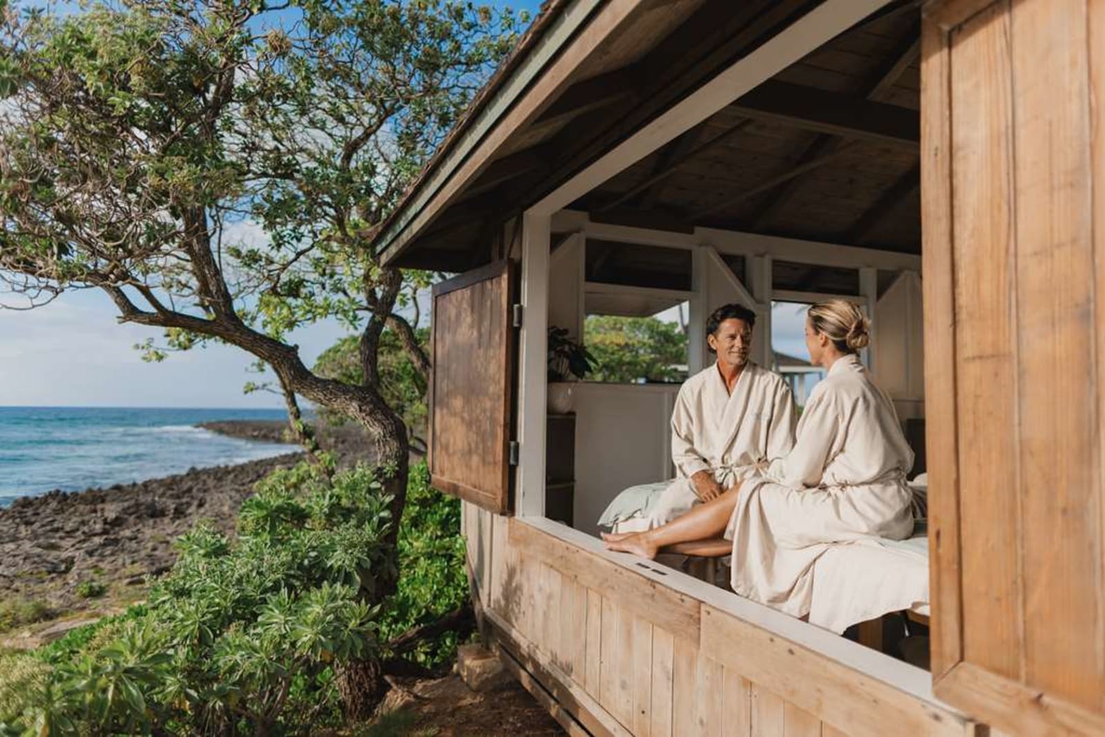 Two guests in spa robes relaxing on an oceanview lanai at The Ritz-Carlton O'ahu, Turtle Bay spa
