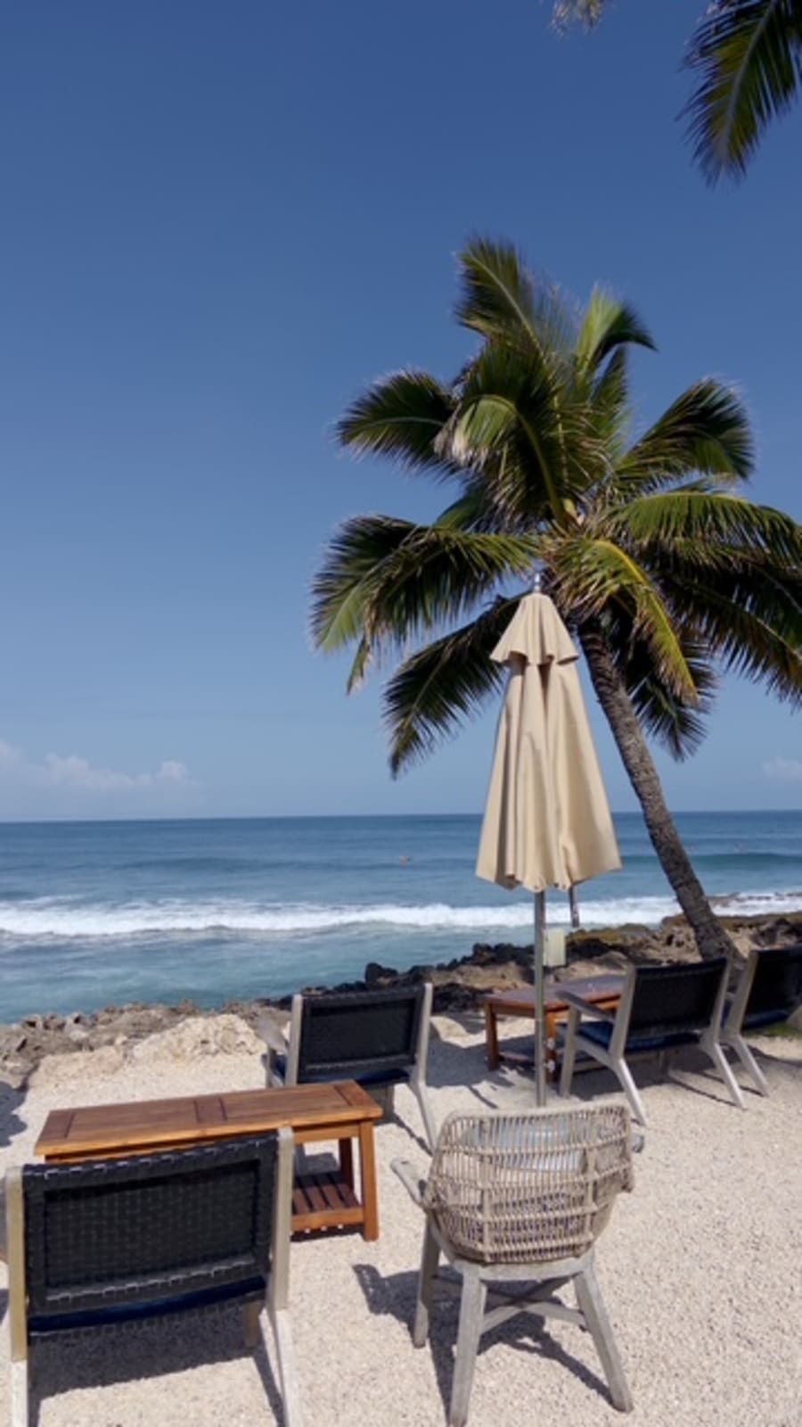 Oceanfront lounge seating at the Sunset pool deck bar, the best spot on property to watch surfers